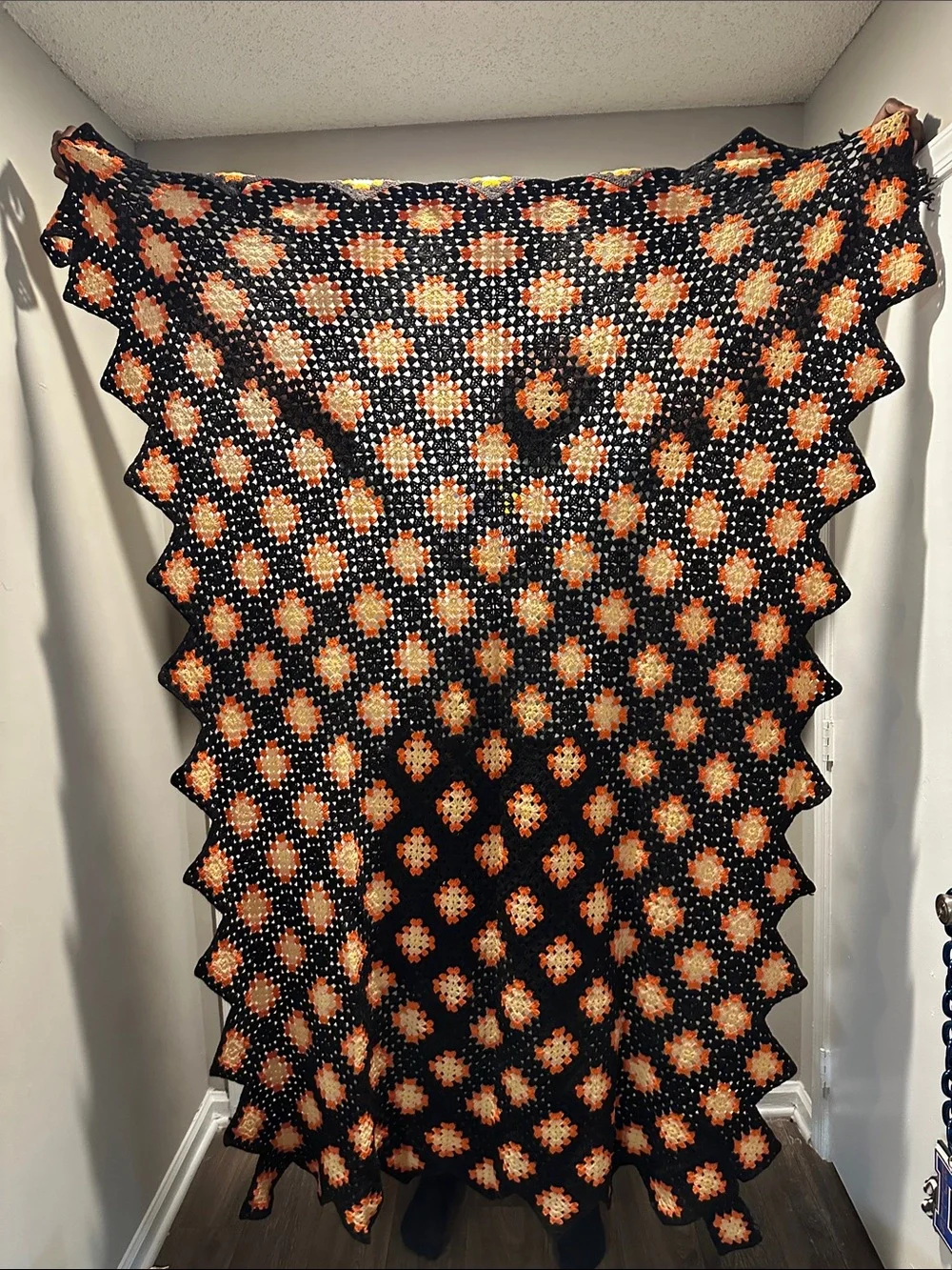 Granny Square black with orange crochet blanket with zig zag hem